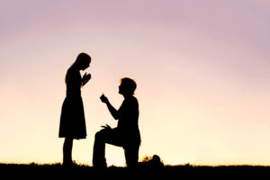 man proposes at sunset